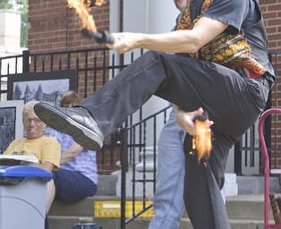 LISA-ANN ISHIHARA | THE VINDICATOR..Erik Kloeker of "The Pickled Brothers" juggles during a teaser act at the Northside Farmers Market for upcoming performances on the corner of Elm St and Illinois Ave, across from Wick Park (in front of First Unitarian Universalist Church).