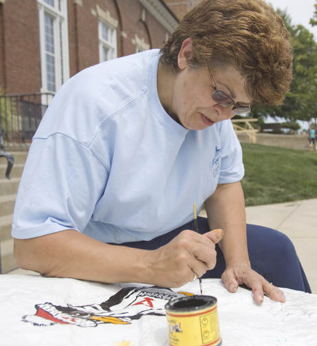 LISA-ANN ISHIHARA | THE VINDICATOR..YSU Director of Admissions Sue Davis paints the mascot onto a rock in the cul de sac outside Kilcawley.. It is called "Making Your Mark" where YSU freshman can sign the rock.