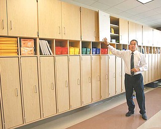 Superintendent Dennis Dunham shows off one of the many storage areas in the elementary wing at the new South Range school building. There are separate wings for middle and high school students. School starts Sept. 8.