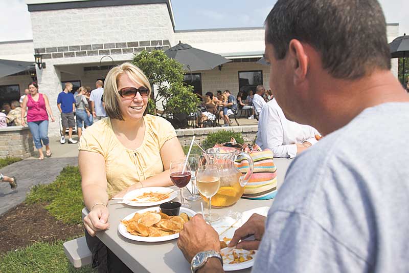 Lisa Grafton of Hinckley and Gary Posage of Salem enjoy refreshments Sunday at the Mastropietro Winery in Berlin Center. The winery was celebrating its fifth anniversary.