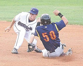 Scrapper shortstop Nick Bartolone, left, tags out Adalberto Santos of the State College Spikes, who was attempting to steal second base, in Tuesday’s New York-Penn League game at Eastwood Field.