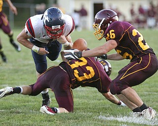 ROBERT K. YOSAY | THE VINDICATOR..JFK  @  SOUTH RANGE-- Big hit by South Range #33  Alex Dickey as he knocks the ball loose from  #1 - NOT ON THE ROSTER  as South Range #26  Floyd Kenney tries to recover the fumble.-30