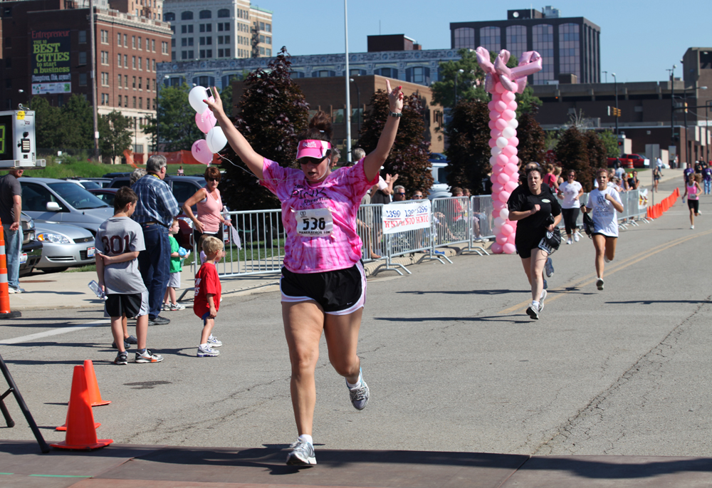 LESLIE CUSANO | THE VINDICATOR.Julie Rauzan of Mix 98.9 crosses the finish line at the Panerathon 10K & 2 mile fun walk/run take off from the starting line Sunday. All money raised from the event will help build the Joanie Abdu Comprehensive Breast Care Center.