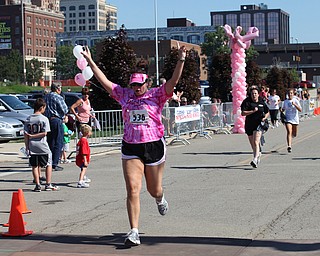 LESLIE CUSANO | THE VINDICATOR.Julie Rauzan of Mix 98.9 crosses the finish line at the Panerathon 10K & 2 mile fun walk/run take off from the starting line Sunday. All money raised from the event will help build the Joanie Abdu Comprehensive Breast Care Center.
