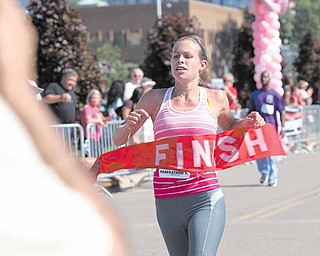 LESLIE CUSANO | THE VINDICATOR.Christina Adams crosses the finish line of the 10K portion of the Panerathon today at the Covelli Center in Downtown Youngstown. Adams was the first female to cross the finish line.