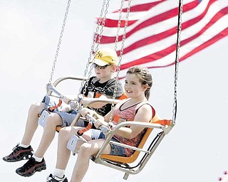 Nick Fromel, 9, of Greenford and Jamie Andrews, 10, of Austintown enjoy riding Vertigo, a swing ride that debuted Wednesday at the Canfield Fair.