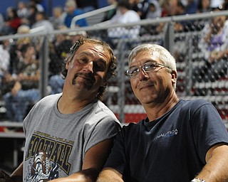 Ed Tkach and Brian Filip of Lowellville watch their sons play during the Lowellville/ Youngstown Christian game Friday. - KELLY TKACH