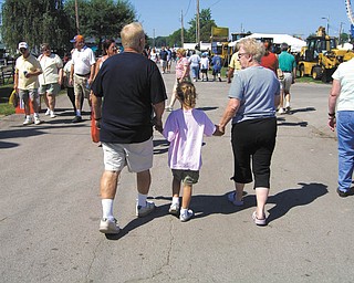Hailey Kadivar of Bradenton, Fla., walks with her grandparents, Bob and Joan Stroh of Poland.