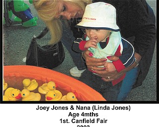 Joey Jones, 4 months, checks out a duck game with his Nana, Linda Jones of Youngstown. This was taken at Joey's first Canfield Fair, in 2003.