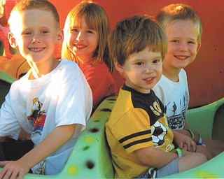 Brothers Ryan, Jason and Evan Sweder, 6, 5 and 3, of Poland and their cousin, Riley Sweder, 6, of Columbus are shown enjoying Kiddie Land.