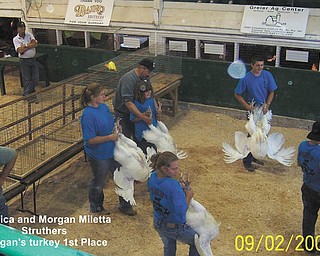 Jessica and Morgan Miletta of Struthers show off their turkeys. Morgan's turkey won first place.
