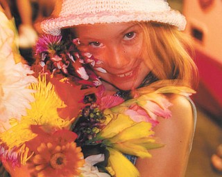 Leanna Hartsough of Canfield stopped to smell the flowers in the Floral Building.