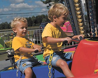 Alex LaPlante, 2, and his brother Nicholas, 5, both of Poland, enjoy the rides at the 2007 Canfield Fair. The shot was taken by their father, John LaPlante.