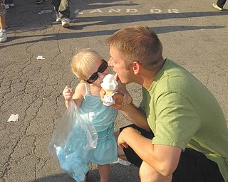 Patrick and MacKenzie Chrystal of Youngstown) share an ice cream cone.
