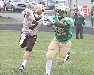 URSULINE - The ball is just out of the reach of (26) Akise Teague as (7) Kyle DeHaut tries to break up the play Saturday afternoon. - Special to The Vindicator/Nick Mays