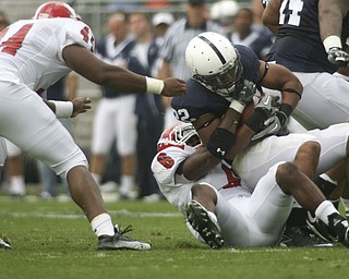 ROBERT K. YOSAY | THE VINDICATOR..YSU #6 Deonta Tate brings down #22 PSU Evan Royster at the line during second quarter action as #44 Andrew Johnson gets in a hand.YSU LOSES 44-14 PENN STATE at BEAVER STADIUM IN HAPPY VALLEY.-30