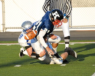 Warren JFK punter #21 Mark Fordeley and Hubbard rusher #9 Taylor Karabin battle for the loose ball after the snap went over Fordeley's head. The ball would be kicked out of the back of the endzone by a JFK player for the saftey.