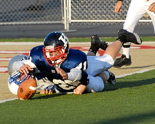 Warren JFK punter #21 Mark Fordeley and Hubbard rusher #9 Taylor Karabin battle for the loose ball after the snap went over Fordeley's head. The ball would be kicked out of the back of the endzone by a JFK player for the saftey.