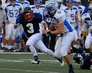 Hubbard Quarterback #6 Michael Lopuchovsky breaks off a 66 yard touchdown run while avoiding the would be tackler of #3 Patrick Hull.