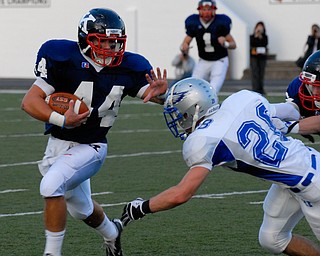 Warren JFK running back #44 James Coates stiff arms the Hubbard tackler #28 Kory Hopkinson.