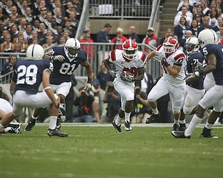 ROBERT K. YOSAY | THE VINDICATOR..***** 80 Yard romp for YSU first touchdown is YSU #29 Dominique Barnes as he breaks the hole - #72 YSU Andrew Radakovich is behind him and he leaves in the dust PSU #28 Drew Astorino #81 Jack Crawford #71 Devon Still and # Graham Zug - this was YSU first TD .YSU LOSES 44-14 PENN STATE at BEAVER STADIUM IN HAPPY VALLEY.-30