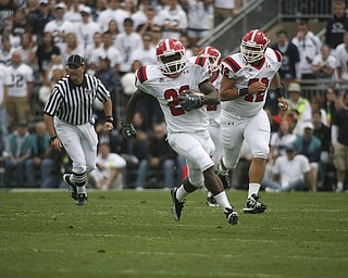 ROBERT K. YOSAY | THE VINDICATOR..***** 80 Yard romp for YSU first touchdown is YSU #29 Dominique Barnes as he breaks the hole - #72 YSU Andrew Radakovich is behind him and he leaves in the dust PSU- this was YSU first TD .YSU LOSES 44-14 PENN STATE at BEAVER STADIUM IN HAPPY VALLEY.-30