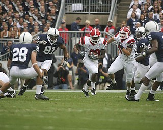 ROBERT K. YOSAY | THE VINDICATOR..***** 80 Yard romp for YSU first touchdown is YSU #29 Dominique Barnes as he breaks the hole - #72 YSU Andrew Radakovich is behind him and he leaves in the dust PSU #28 Drew Astorino #81 Jack Crawford #71 Devon Still and # Graham Zug - this was YSU first TD .YSU LOSES 44-14 PENN STATE at BEAVER STADIUM IN HAPPY VALLEY.-30