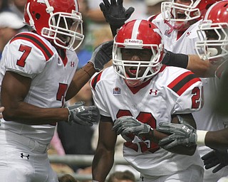 ROBERT K. YOSAY | THE VINDICATOR..***** 80 Yard romp for YSU first touchdown is YSU #29 Dominique Barnes as he was congratulated by teamates #7 Ely Ducatel and #72 Andrew Radakovich -YSU first TD .YSU LOSES 44-14 PENN STATE at BEAVER STADIUM IN HAPPY VALLEY.-30