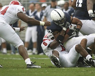 ROBERT K. YOSAY | THE VINDICATOR..YSU #6 Deonta Tate brings down #22 PSU Evan Royster at the line during second quarter action as #44 Andrew Johnson gets in a hand.YSU LOSES 44-14 PENN STATE at BEAVER STADIUM IN HAPPY VALLEY.-30