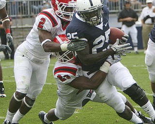 ROBERT K. YOSAY | THE VINDICATOR..YSU #23 Nick Gooden Tackles #25 PSU Silas Redd with the help of YSU #2 Andre Elliott during third quarter action..YSU LOSES 44-14 PENN STATE at BEAVER STADIUM IN HAPPY VALLEY.-30