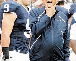 Penn State coach Joe Paterno, right, stands on the sidelines during the fourth quarter of an NCAA college football game against Youngstown State in State College, Pa., Saturday, Sept. 4, 2010. Penn State won 44-14. At left is running back Michael Zordich (9). (AP Photo/Gene J. Puskar)