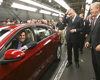 ROBERT K. YOSAY | THE VINDICATOR..GM North America President Mark Reuss - behind the wheel - Lee Fisher and Gov. Ted Strickland aas it comes off the GM Lordstown Kicked Off the Chevy Cruze today at the Lordstown Plant with the President of GM - Tim Ryan - The Boardman Band and a slew of elected officials -..-30-..
