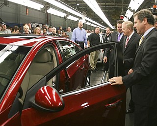ROBERT K. YOSAY | THE VINDICATOR..GM North America President Mark Reuss - Gov. Ted Strickland and Sherrod Brown inspect a Cruze as it comes off the GM Lordstown Kicked Off the Chevy Cruze today at the Lordstown Plant with the President of GM - Tim Ryan - The Boardman Band and a slew of elected officials -..-30-..