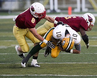 ROBERT K. YOSAY | THE VINDICATOR..#10 Kevin Burke for St Eds is brought down by Mooneys #8 Nick Gemma and #6 Jarvis Abrams as Cardinal Mooney vs St. Ed's at Fitch Stadium..-30