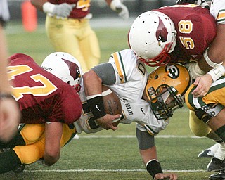 ROBERT K. YOSAY | THE VINDICATOR..CM #47 Pat McGlone and #58 Ryan Cook bring down #10 Kevin Burke for St Eds at the line during the second quarter Cardinal Mooney vs St. Ed's at Fitch Stadium..-30