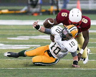 ROBERT K. YOSAY | THE VINDICATOR..CM #6 Jarvis Abrams brings down St Eds #10 Kevin Burke and jars the ball loose during first quarter action - Cardinal Mooney vs St. Ed's at Fitch Stadium..-30