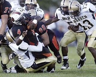 William D Lewis|The Vindicator Howland's Deveon Smith is brought down by a host of Raiders during 1 rst qtr action Friday at Howland.