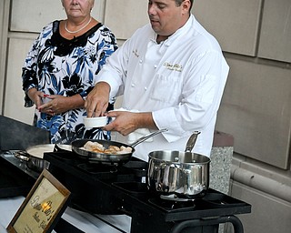 Alan Donatelli of DonaVito’s Italian Grill in Struthers was assisted by his mother, Beverly Bucci, as he instructed participants in making Seafood a la Mariotti at last year’s Chefs’ Secrets event. Donatelli will offer the class again at this year’s event, on Sept. 19.