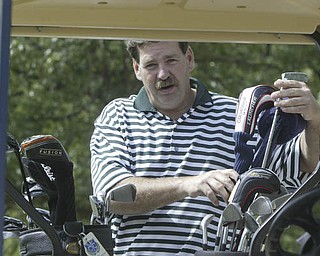 William D. Lewis| The Vindicator George Allen picks out a club at Greatest Golf Tourney Saturday.