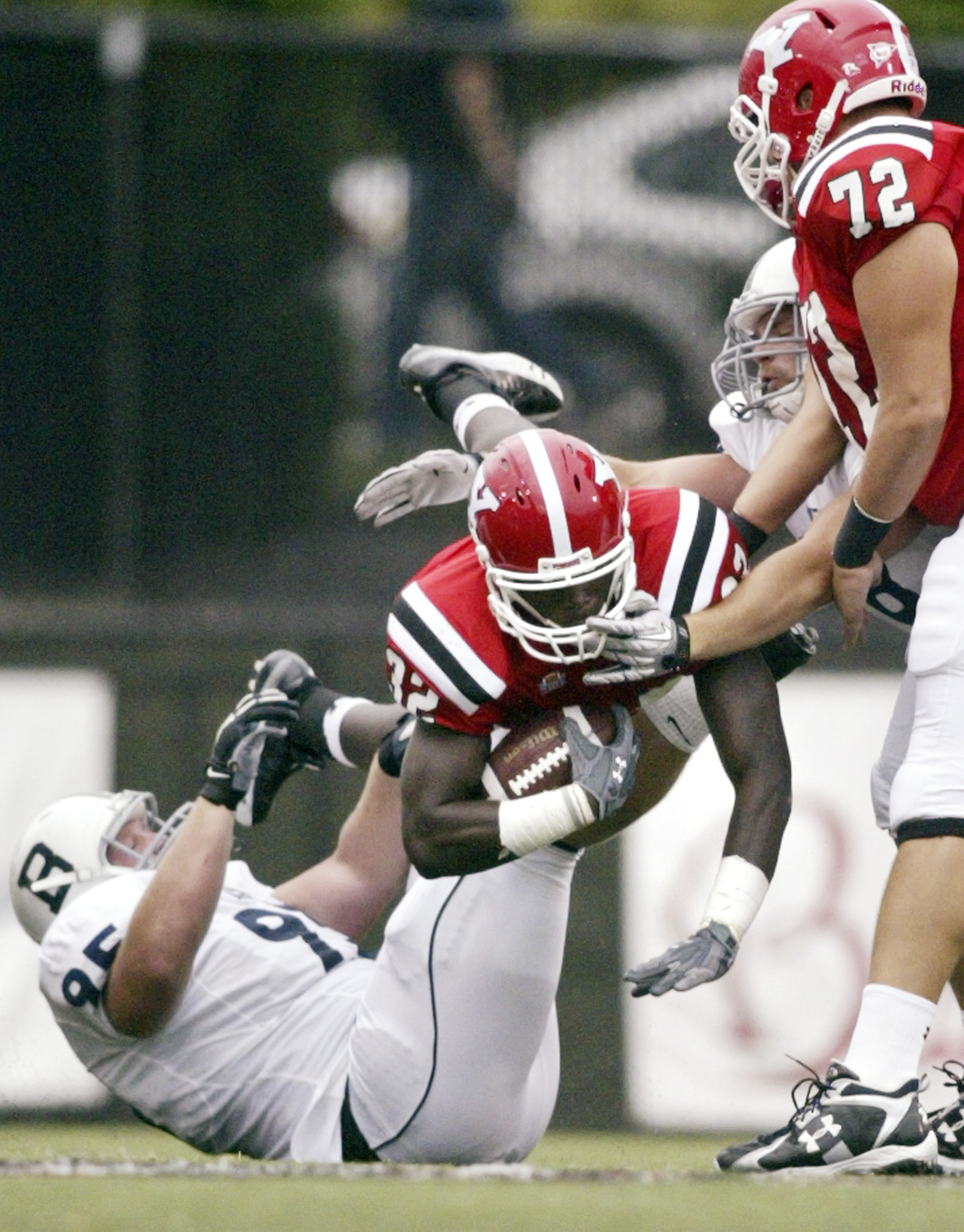 William D LEwis The Vindicator  YSU's Jordan Thompson dives past Butler's Taylor Clarkson for 1 rst quater yardage. At right is ysu's Andrew Radakovich.