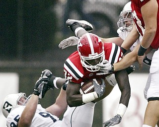 William D LEwis The Vindicator YSU's Jordan Thompson dives past Butler's Taylor Clarkson for 1 rst quater yardage. At right is ysu's Andrew Radakovich.
