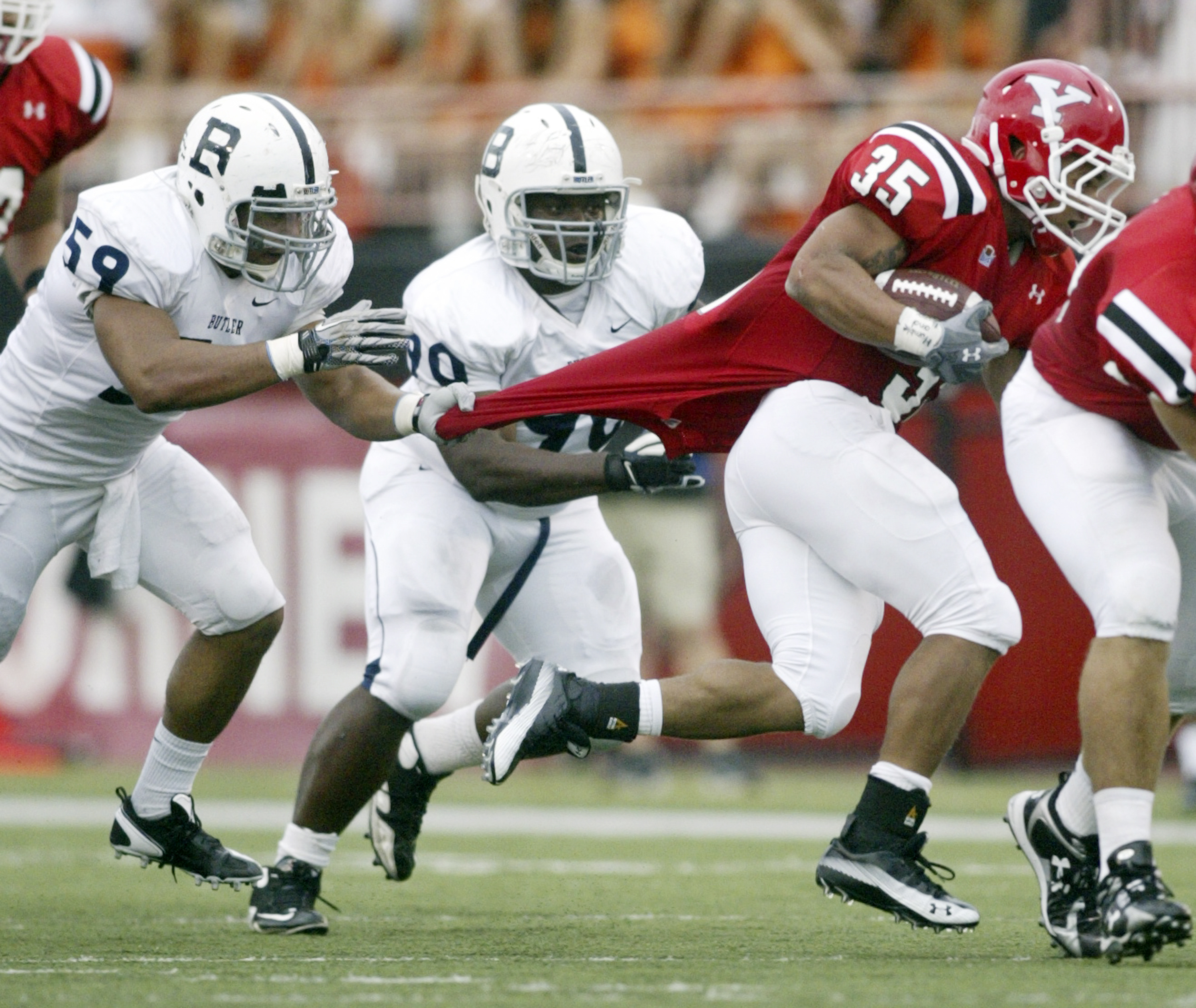 William DLEwis  The Vindicator  Butler's Jordan ridley gets a piece of YSU's Jamaine Cook.Center is Butlers JT Mesch