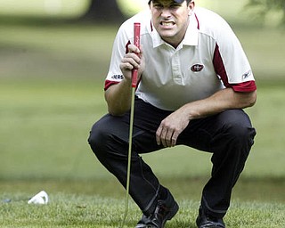 William D Lewis | The Vindicator Mike Porter sudies a put at TCC Sunday.