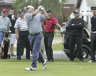 William D Lewis | The Vindicator Gordon Price tees off as other golfers look on at TCC Sunday.