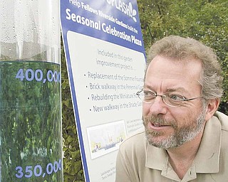 Keith Kaiser, above, Mill Creek Park horticulture director, looks at the fountain gauge in Fellows Riverside Gardens that is keeping track of fundraising to replace the Sommer Fountain.