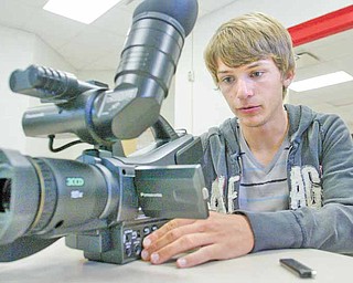 Jeff Schallick, a junior at Columbiana High School, reviews video on a video camera in the school’s video lab.