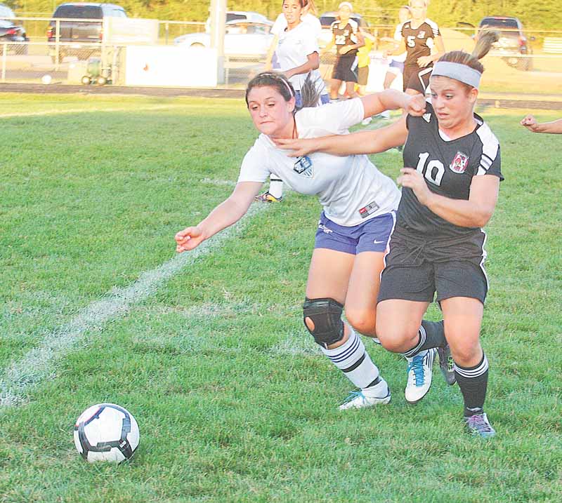 (10) Paige Baker of Canfield and Desiree Nuss (4) of Lakeview fight for the ball Monday night in Lakeview.