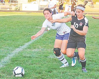 (10) Paige Baker of Canfield and Desiree Nuss (4) of Lakeview fight for the ball Monday night in Lakeview.