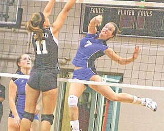 Elaine Kelley (7) of Lakeview spikes the ball past Lindsey Crown (11) of Girard Tuesday night’s All-American
Conference volleyball match in Girard.