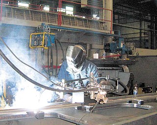 Steve Smith, a fitter and welde at Butech Bliss in Salem on Tuesday .worked on a special lifting beam that will only be used in the .teardown and reinstallation of steel shears in Europe.